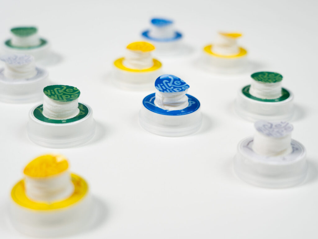 Multiple popped open Wicked Wipes pods on a white table